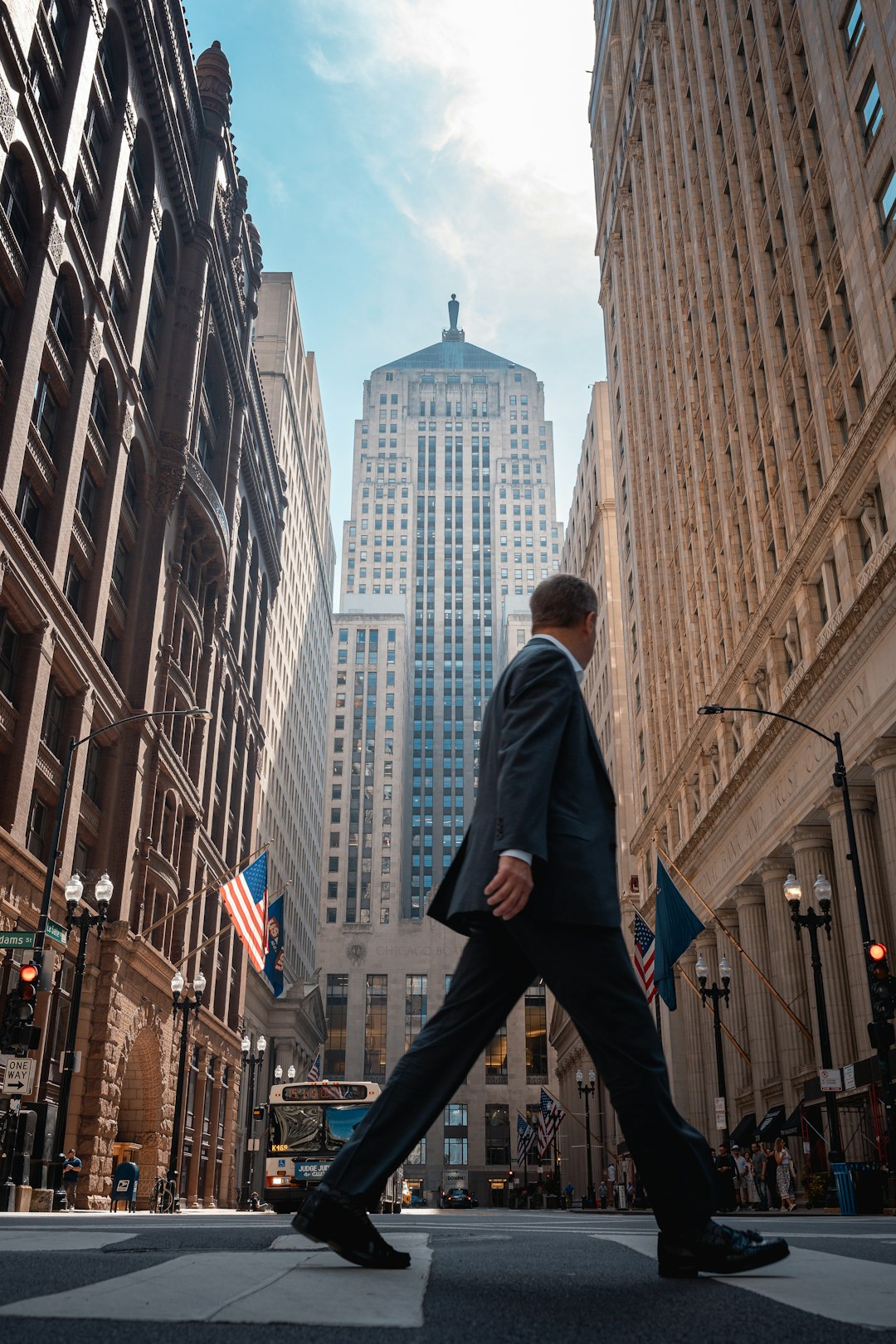 a-man-in-a-suit-walking-across-a-street-zb33avwsa7i